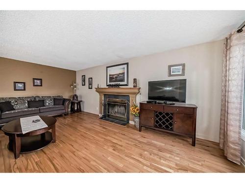 4509 49 Street, Sylvan Lake, AB - Indoor Photo Showing Living Room With Fireplace