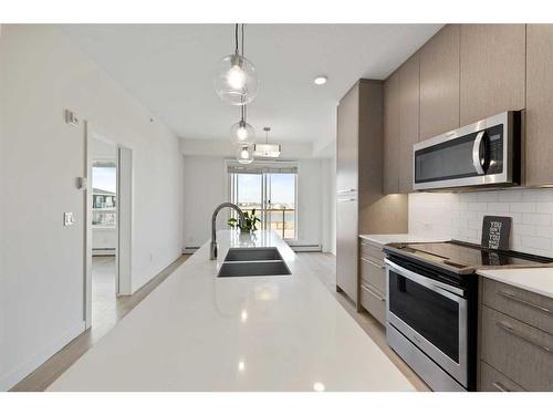 1404-76 Cornerstone Passage Ne, Calgary, AB - Indoor Photo Showing Kitchen With Double Sink With Upgraded Kitchen