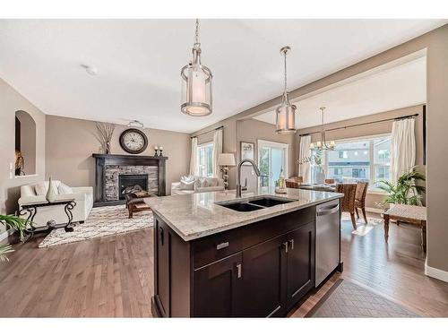 60 Aspen Hills Place Sw, Calgary, AB - Indoor Photo Showing Kitchen With Fireplace With Double Sink