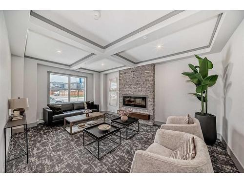 301-55 Wolf Hollow Crescent Se, Calgary, AB - Indoor Photo Showing Living Room With Fireplace