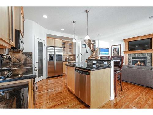 36 Ypres Way Sw, Calgary, AB - Indoor Photo Showing Kitchen With Fireplace With Stainless Steel Kitchen