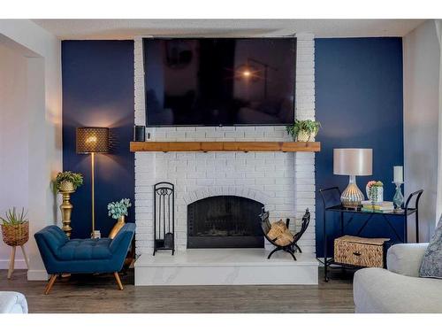 96 Coach Manor Terrace Sw, Calgary, AB - Indoor Photo Showing Living Room With Fireplace