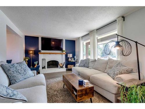 96 Coach Manor Terrace Sw, Calgary, AB - Indoor Photo Showing Living Room With Fireplace