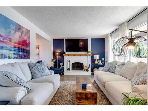 96 Coach Manor Terrace Sw, Calgary, AB - Indoor Photo Showing Living Room With Fireplace