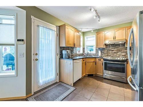 50 Hidden Ranch Circle Nw, Calgary, AB - Indoor Photo Showing Kitchen With Double Sink