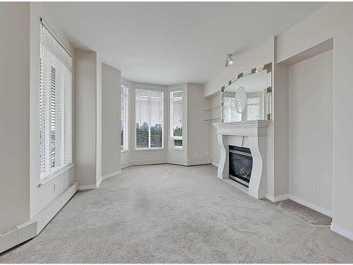 309-1718 14 Avenue Nw, Calgary, AB - Indoor With Fireplace