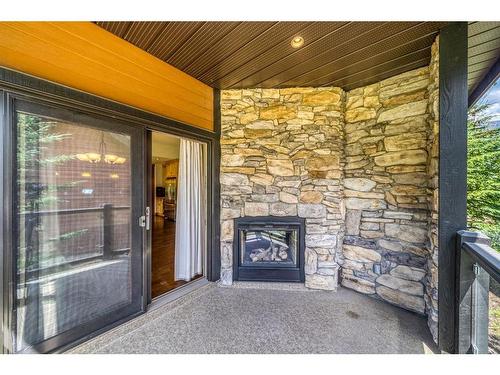 105 Riva Court, Canmore, AB - Outdoor With Fireplace With Deck Patio Veranda With Exterior