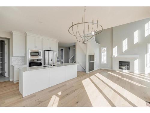 108 Cimarron Estates Drive, Okotoks, AB - Indoor Photo Showing Kitchen With Fireplace