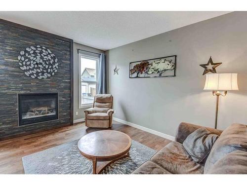 243 Copperpond Bay Se, Calgary, AB - Indoor Photo Showing Living Room With Fireplace