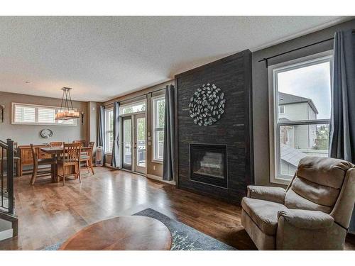 243 Copperpond Bay Se, Calgary, AB - Indoor Photo Showing Living Room With Fireplace