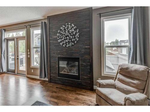 243 Copperpond Bay Se, Calgary, AB - Indoor Photo Showing Living Room With Fireplace