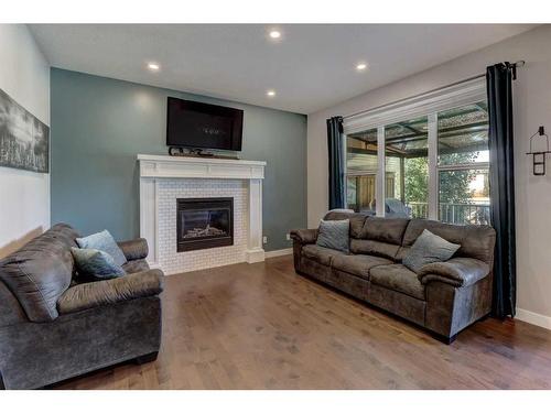 88 Cooperstown Place Sw, Airdrie, AB - Indoor Photo Showing Living Room With Fireplace