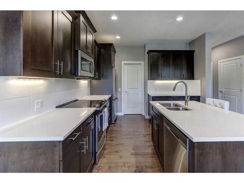 88 Cooperstown Place Sw, Airdrie, AB - Indoor Photo Showing Kitchen With Double Sink With Upgraded Kitchen