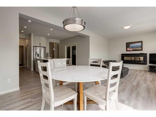 33 Sage Bluff Close Nw, Calgary, AB - Indoor Photo Showing Dining Room With Fireplace