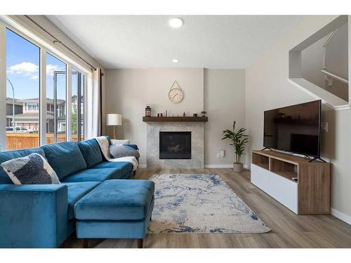 6 Magnolia Manor Se, Calgary, AB - Indoor Photo Showing Living Room With Fireplace