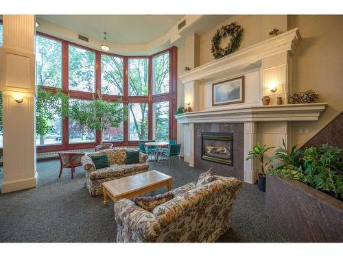 334-1920 14 Avenue Ne, Calgary, AB - Indoor Photo Showing Living Room With Fireplace