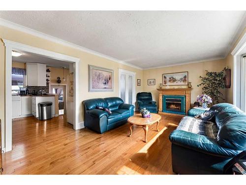 3411 Bowcliffe Crescent Nw, Calgary, AB - Indoor Photo Showing Living Room With Fireplace