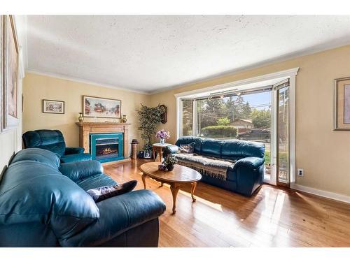 3411 Bowcliffe Crescent Nw, Calgary, AB - Indoor Photo Showing Living Room With Fireplace