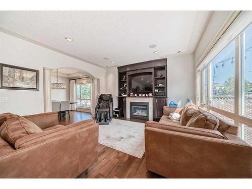 4 Rockcliff Point Nw, Calgary, AB - Indoor Photo Showing Living Room With Fireplace