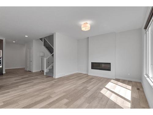 105 Creekstone Path Sw, Calgary, AB - Indoor Photo Showing Living Room With Fireplace