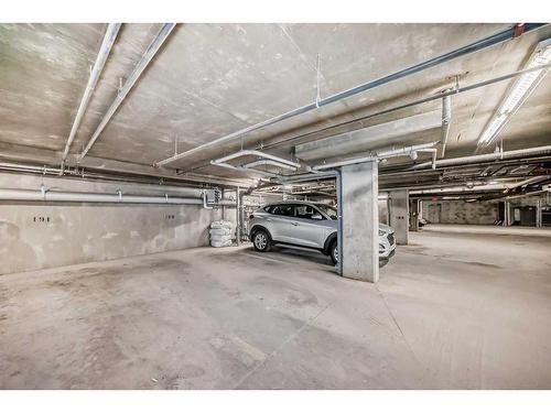 2111-403 Mackenzie Way Sw, Airdrie, AB - Indoor Photo Showing Garage