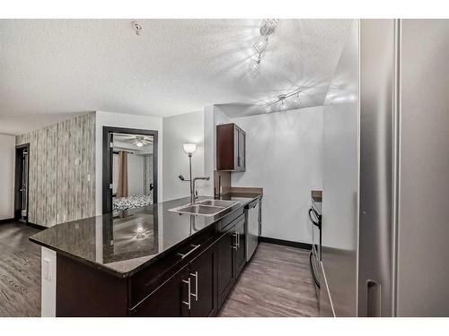 2111-403 Mackenzie Way Sw, Airdrie, AB - Indoor Photo Showing Kitchen With Double Sink