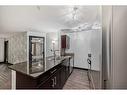 2111-403 Mackenzie Way Sw, Airdrie, AB  - Indoor Photo Showing Kitchen With Double Sink 