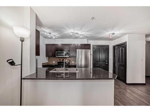 2111-403 Mackenzie Way Sw, Airdrie, AB - Indoor Photo Showing Kitchen With Stainless Steel Kitchen With Double Sink