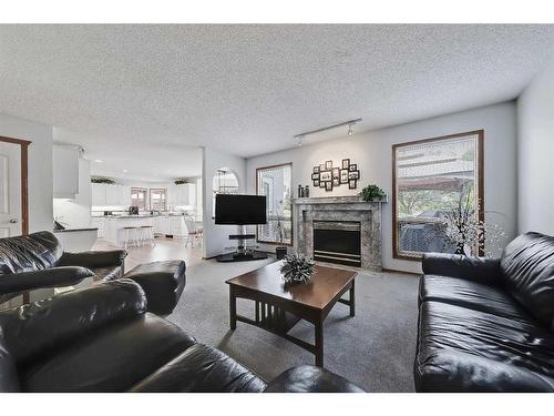 170 Woodpark Circle Sw, Calgary, AB - Indoor Photo Showing Living Room With Fireplace