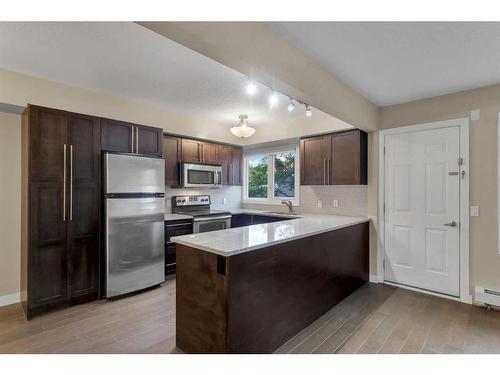 102-1508 23 Avenue Sw, Calgary, AB - Indoor Photo Showing Kitchen With Stainless Steel Kitchen