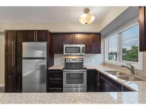 102-1508 23 Avenue Sw, Calgary, AB - Indoor Photo Showing Kitchen With Stainless Steel Kitchen With Double Sink