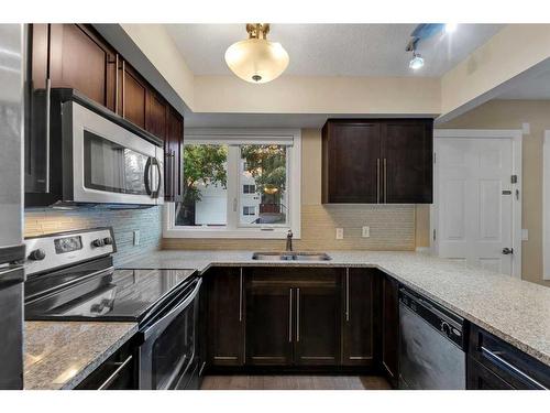 102-1508 23 Avenue Sw, Calgary, AB - Indoor Photo Showing Kitchen With Stainless Steel Kitchen With Double Sink