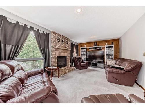 120 Millrise Drive Sw, Calgary, AB - Indoor Photo Showing Living Room With Fireplace