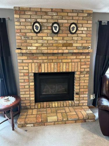 120 Millrise Drive Sw, Calgary, AB - Indoor Photo Showing Living Room With Fireplace