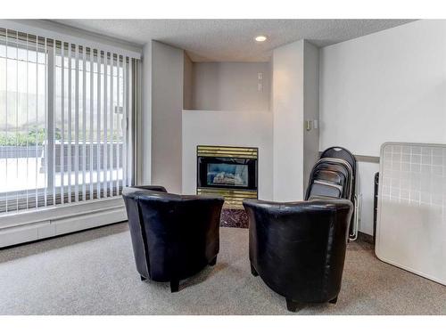 219-525 56 Avenue Sw, Calgary, AB - Indoor With Fireplace