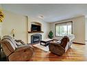 140 Cranwell Crescent Se, Calgary, AB  - Indoor Photo Showing Living Room With Fireplace 