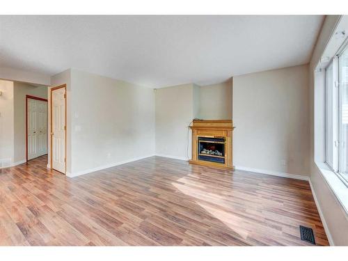 115 Mt Apex Crescent Se, Calgary, AB - Indoor Photo Showing Living Room With Fireplace