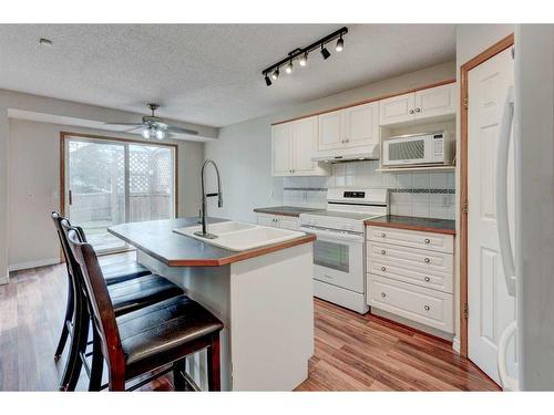 115 Mt Apex Crescent Se, Calgary, AB - Indoor Photo Showing Kitchen With Double Sink