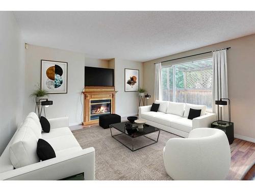 115 Mt Apex Crescent Se, Calgary, AB - Indoor Photo Showing Living Room With Fireplace