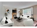 115 Mt Apex Crescent Se, Calgary, AB  - Indoor Photo Showing Living Room With Fireplace 