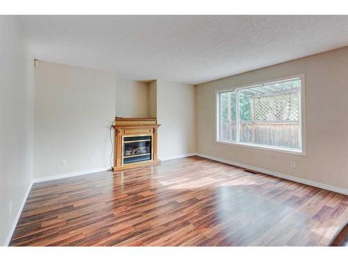 115 Mt Apex Crescent Se, Calgary, AB - Indoor Photo Showing Living Room With Fireplace