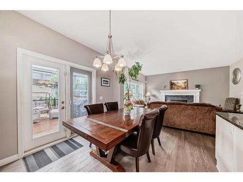 54 Masters Mews Se, Calgary, AB - Indoor Photo Showing Dining Room With Fireplace