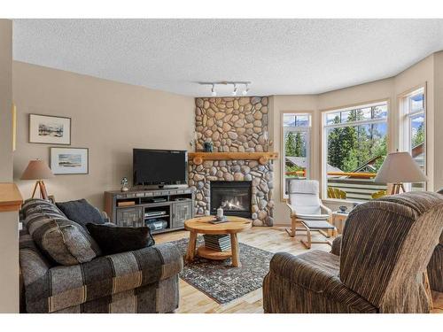 1077 Wilson Way, Canmore, AB - Indoor Photo Showing Living Room With Fireplace