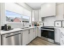 63 Heirloom Boulevard Se, Calgary, AB  - Indoor Photo Showing Kitchen With Stainless Steel Kitchen With Double Sink 