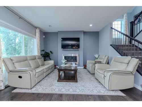 52 Cooperstown Place Sw, Airdrie, AB - Indoor Photo Showing Living Room With Fireplace