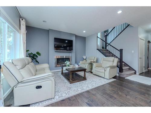 52 Cooperstown Place Sw, Airdrie, AB - Indoor Photo Showing Living Room With Fireplace