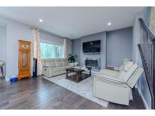 52 Cooperstown Place Sw, Airdrie, AB - Indoor Photo Showing Living Room With Fireplace