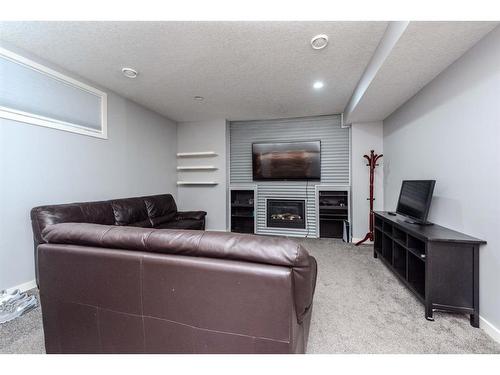 52 Cooperstown Place Sw, Airdrie, AB - Indoor With Fireplace