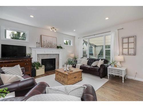 234 Baywater Way Sw, Airdrie, AB - Indoor Photo Showing Living Room With Fireplace