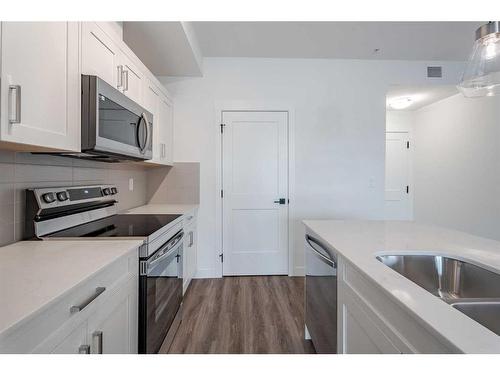 1110-200 Seton Circle Se, Calgary, AB - Indoor Photo Showing Kitchen With Double Sink